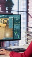Vertical Professional architectural designer configures a floor plan on dual monitors, utilizing computer aided design tools. Woman uses digital rendering and interior decoration remodeling. Camera A. video