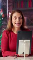 Vertical Confident happy female speaker greeting colleagues on a call discussion, enjoying the benefits of online remote communication in apartment. Businesswoman hosting virtual meeting. Camera A. video