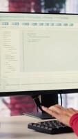 Vertical Freelancer typing commands into a futuristic AI chatbot to help solve tasks, artificial intelligence demonstrates the power of automation and virtual assistance for efficiency. Camera A. video