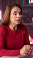 Vertical Displeased angry team leader yelling at her employees on web conference, attending an online call meeting for briefing and getting irritated of careless workers. Impatience. Camera A. video