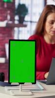 Vertical Person uses laptop for creative projects next to isolated copy space, creating designs while staying connected to the freelance platform. Woman focusing on research and multitasking. Camera A. video