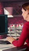 Vertical Woman typing on a computer and chatting with an AI assistant. Futuristic interface highlights artificial intelligence, machine learning and automated solutions for productivity. Camera A. video