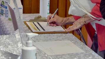 people signing the covid19 contact tracing list before entering premises in New Zealand after lock down video