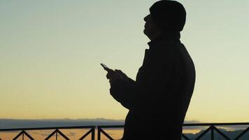 Silhouette of a Man Taking Photographs with His Smartphone at Sunset video