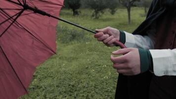 Caucasian Woman Opens Red Umbrella For Rain On A Meadow In Forest video