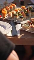 The chef sets the table with ready-made food and drinks and a luxury yacht. Sunny summer day video
