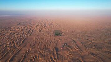 A drone over the sand dunes of the desert in Dubai. A sunny summer day, a deserted road. video