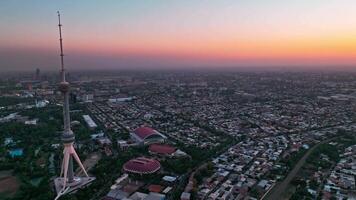A drone over the evening streets of Tashkent against the backdrop of a sunset. View of the TV Tower video