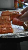 Chef arranges pieces of raw fish on a tray before frying video