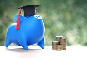 Graduation hat on piggy and stack of coins money photo