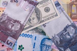 A background of paper banknotes of different currencies photo