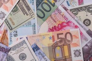 Paper banknotes of different currencies photo