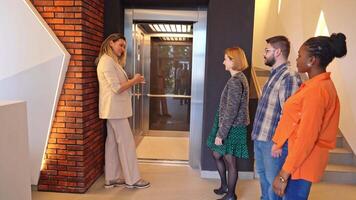 Group of friends eagerly waiting for the elevator in a modern building video