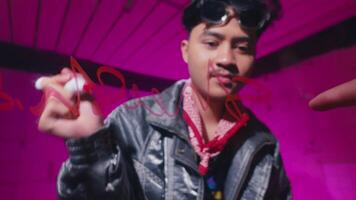 Young Man Drawing with Red Marker in Vibrant Setting video