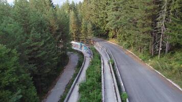 Sarajevo, Bosnia and Herzegovina 08-26-2024, Abandoned bobsleigh track in Sarajevo. track immersed in the forest and painted with graffiti. It was used in the 1984 Sarajevo Winter Olympics video