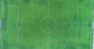 Zenithal top down aerial drone view of the centre of a football soccer pitch with players training video