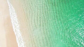 footage of a paradisiacal beach of turquoise waters from a zenithal drone view. Summer concept background video