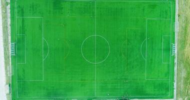 Top down aerial drone view of the centre of a football soccer pitch with players training video