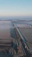 An aerial view of a highway in the middle of a foggy field video