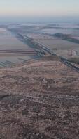An aerial view of a highway and a field video