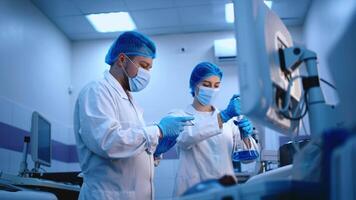 A team of scientists in gloves, glasses, and hats conducts biochemical research in a modern laboratory. Concept studying biological processes with advanced scientific methods video