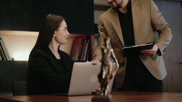 Side view of caucasian businesswoman take a note and working with laptop at office. Legal expert, professional lawyer checking business data and contract before giving advice to a client video