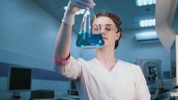 Female uses lab equipment for an experiment, working with test tubes and samples. Concept scientific research and experiments using cutting-edge technology in the laboratory video