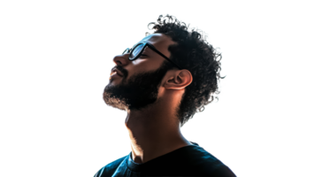 Curly haired man in glasses gazes at sunset png