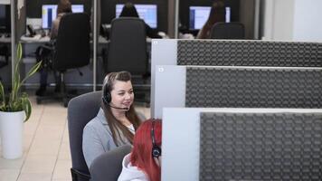 Customer service representatives working in a call center providing assistance video