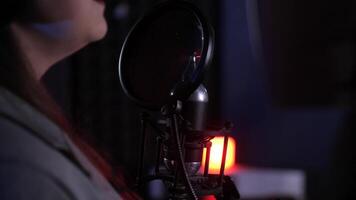 Singer recording music using professional microphone in studio video