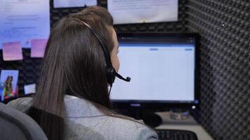 Call center operator working on computer with headset video