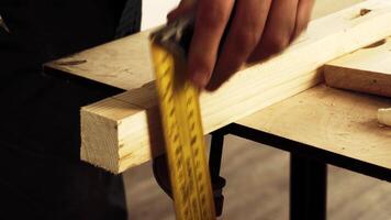 Crafting a precise measurement using tools at a woodworking station in a workshop setting video