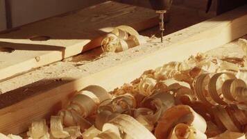 Woodworking in a sunlit workshop with shavings and tools creating a serene atmosphere video