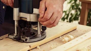 Crafting a wooden project with a router at a workshop on a sunny afternoon video