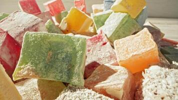 Colorful assortment of traditional Turkish delight in a sunlit setting with various flavors video