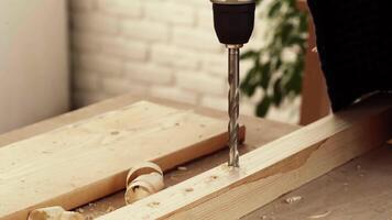 Discovering woodworking techniques while drilling into softwood at a workshop in a bright indoor space video