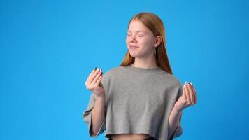 Enjoying a joyful moment with a playful expression against a vibrant blue background video
