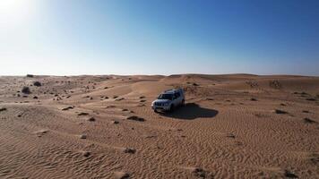 Drone over cars in the sand dunes of the desert with tourists. Dubai, a sunny summer day video