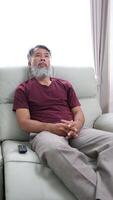 Elderly man in later years journaling, calling a friend, and relaxing at home. video