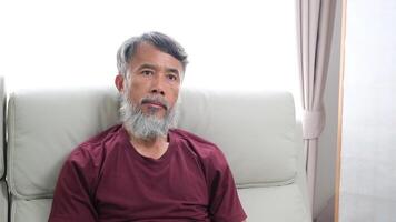 Elderly man in later years journaling, calling a friend, and relaxing at home. video