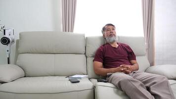 Elderly man in later years journaling, calling a friend, and relaxing at home. video