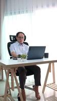 Elderly father using laptop to update news while relaxing in retirement at home. video