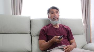 Elderly man in later years journaling, calling a friend, and relaxing at home. video