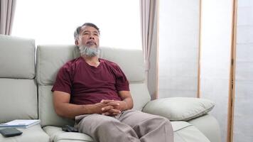 Elderly man in later years journaling, calling a friend, and relaxing at home. video