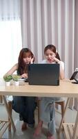 Two teenage girls studying online on laptops at home. video