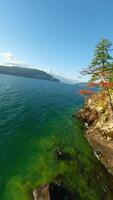 FPV Aerial view of colourful forest on mountain slopes and Harrison Lake. Canada video