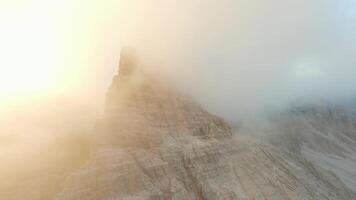 FPV drone flying in the clouds close to the mountain cliffs. Italy, Dolomites video