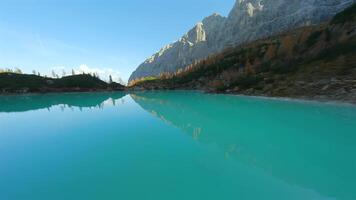 FPV drone flying close to the sharp mountain cliffs and Lake Sorapis. Italy. video