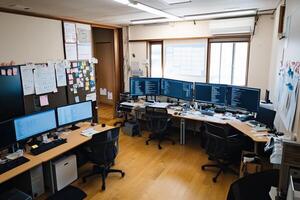 Busy Office Space With Multiple Computer Monitors And Desk Clutter photo