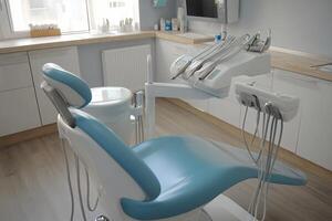 A dental chair with a sink and a sink photo